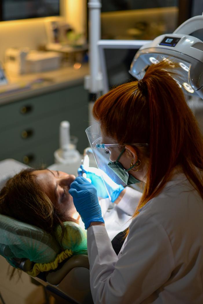 Dentist performing a careful examination with a patient in the chair