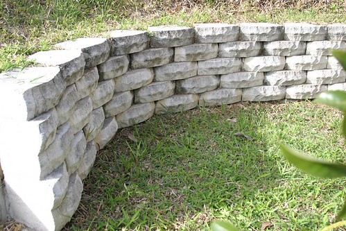 A curved residential retaining wall built from split-face block